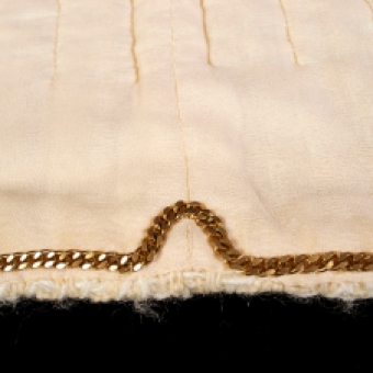 Another distinctive element of a Chanel jacket is the chain used as a weight along the hem. The weighted bottom ensures that the jacket will lay flat.