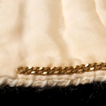 The edges of the jacket along the collar, the front opening and the bottom hem are finished with whipstitches that are decorative and functional.