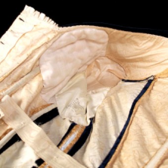 One of the benefits of custom made clothing is that it can compensate for perceived figure flaws. A peak inside this bodice reveals that the bust has been generously enhanced with padding.