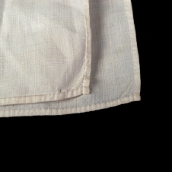Every edge of the fabric is expertly finished, particularly the tiny rolled hem along the bottom.