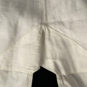 The shirt is reinforced at the top of the side slit. This image shows the interior of the shirt.
