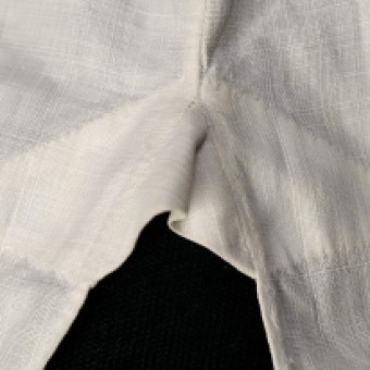 The shirt is reinforced at the top of the side slit. This image shows the exterior of the shirt.
