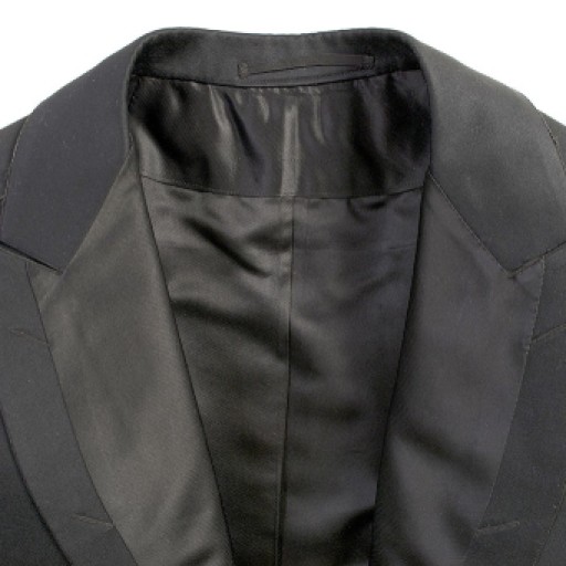 The silk lining, which continues onto the face of the lapels is handstitched along the edges. The label that was originally in the back of the neck has been removed.